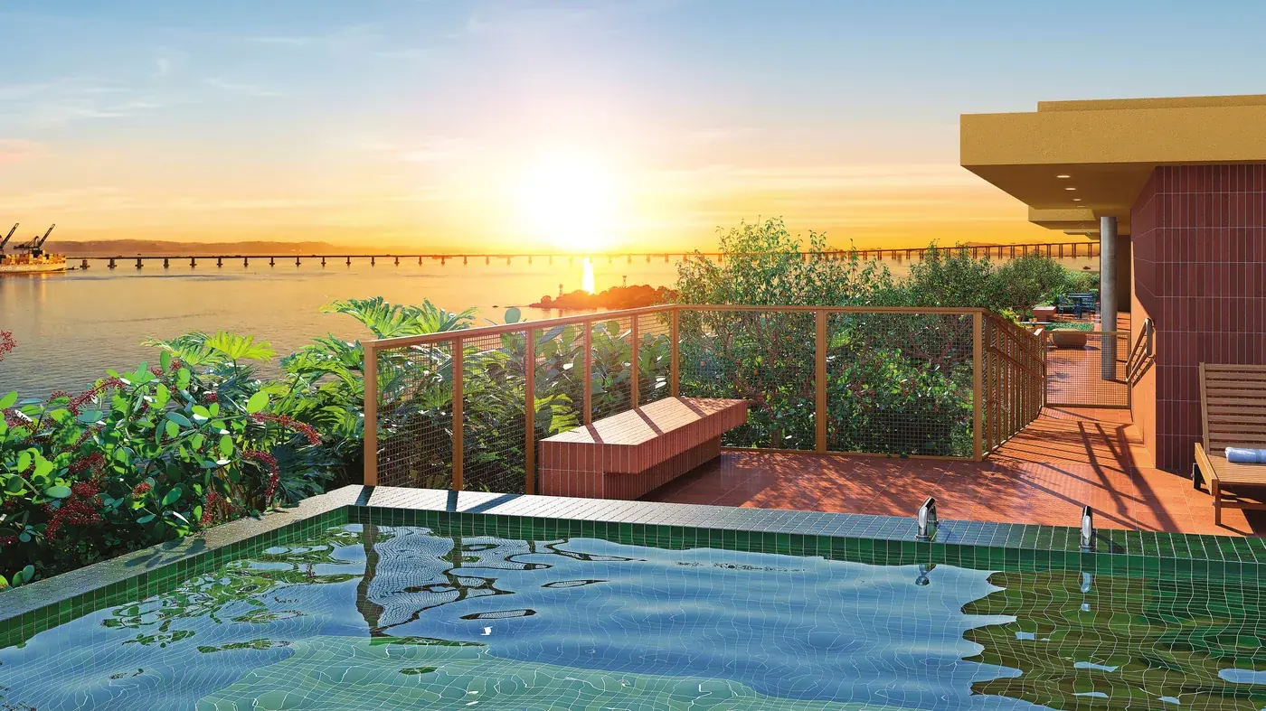 Deck descoberto da piscina do Residencial Erê ao pôr do sol, com vista para a Baía de Guanabara